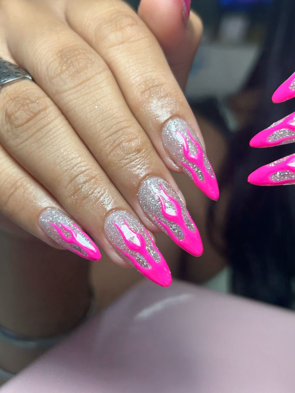 Close up of professional elegant manicured nails, soft rose pink and gold leaf delicate nail art design, clean aesthetic hands on a neutral textured linen surface, beauty salon portfolio photography, natural soft studio lighting
